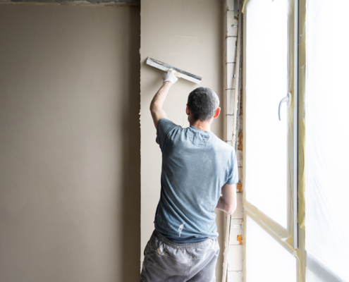 Construction Worker Wearing Worker Overall With Wall Plastering