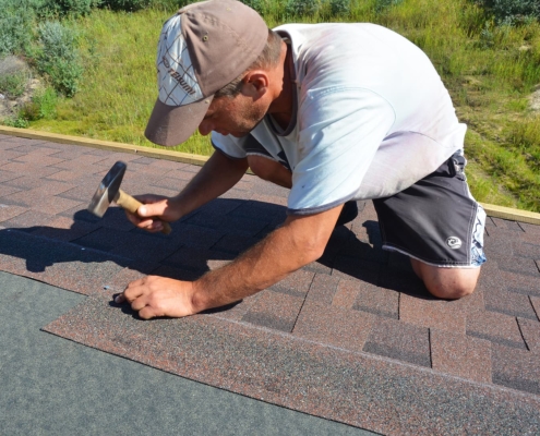 man repairing roof