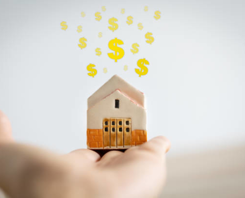 woman holding home model on hand with dollar signs above, investment concept